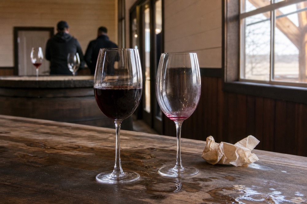 Two glasses of Italian red wine compared on a tasting table, no text, no logos, no people