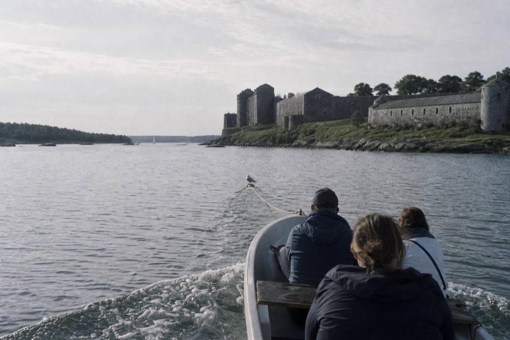 A boat on Lake Garda approaching Sirmione's castle, no text, no logos, no people