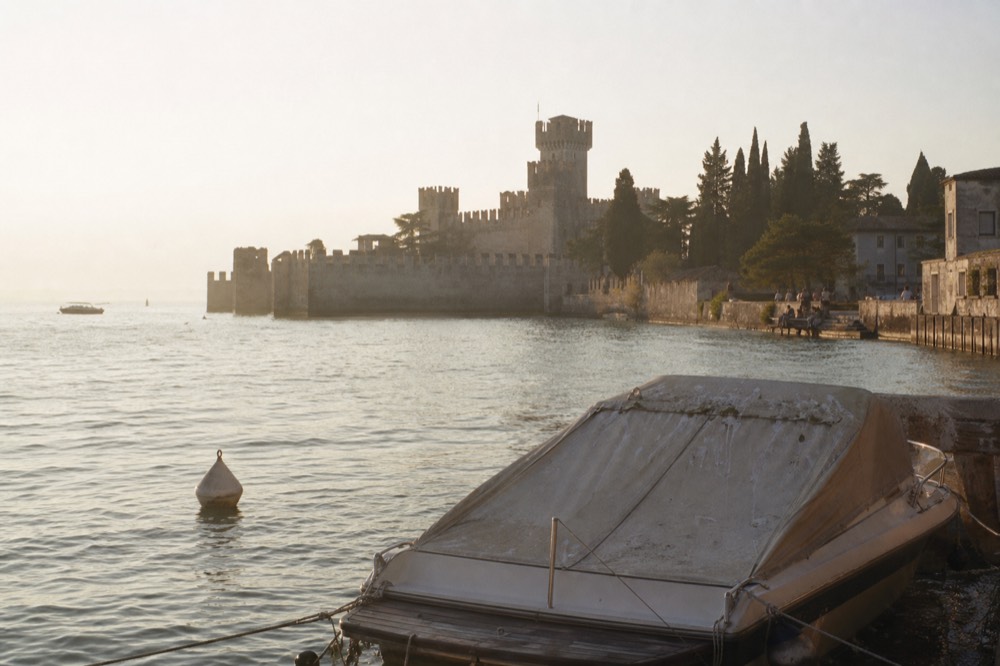 Sirmione peninsula seen from the water with Scaligero castle walls, no text, no logos, no people
