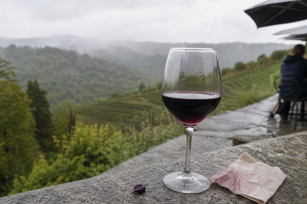 Amarone wine glass with Valpolicella hills, no text, no logos, no people
