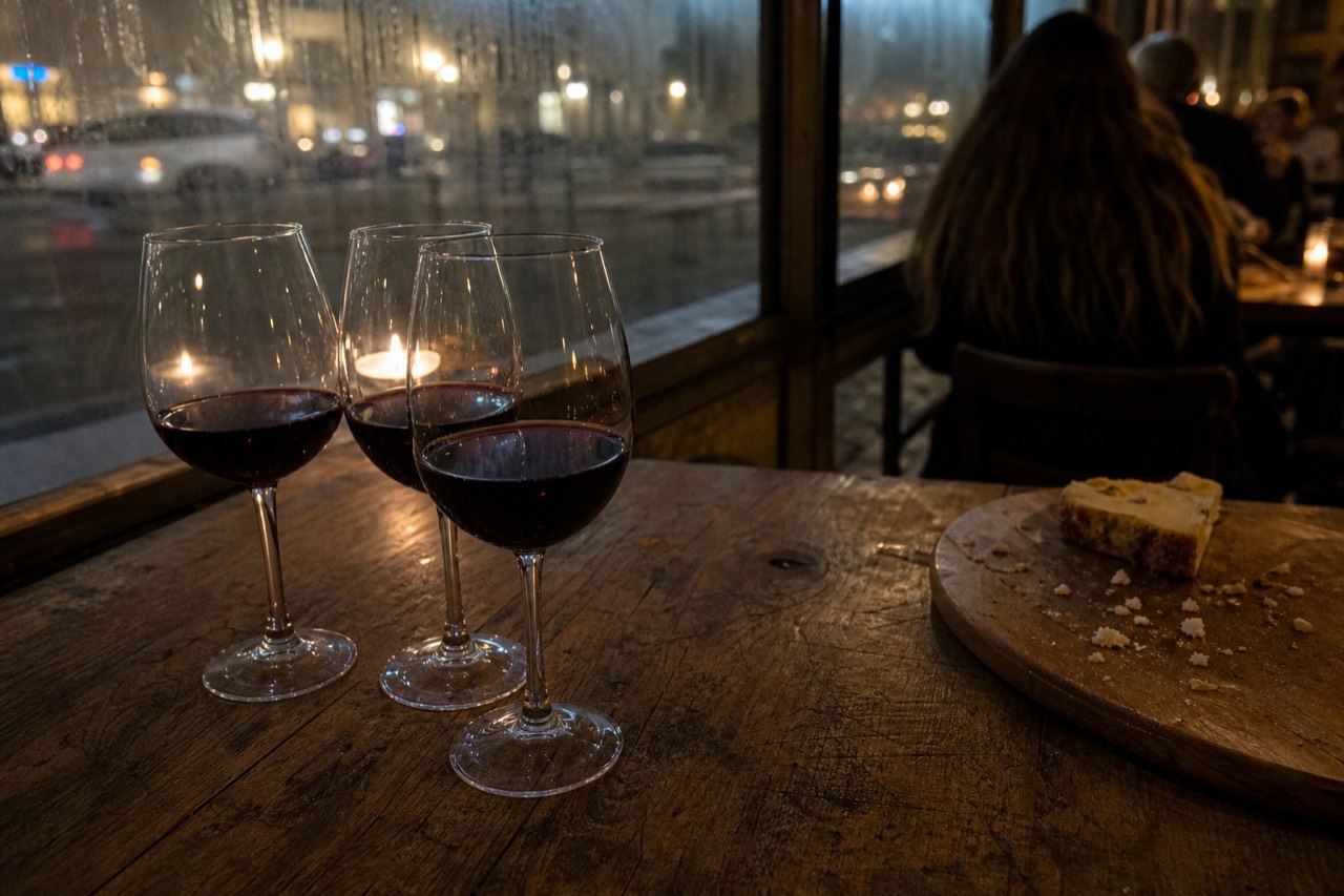 Glasses of red wine on a rustic table in a Verona wine bar, no text, no logos, no people