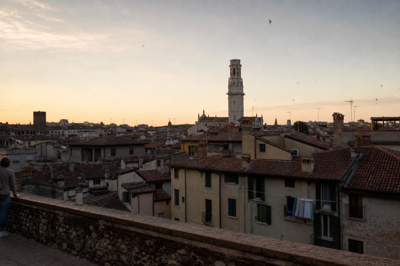 Rooftops of Verona old town with the Lamberti tower in evening light, no text, no logos, no people