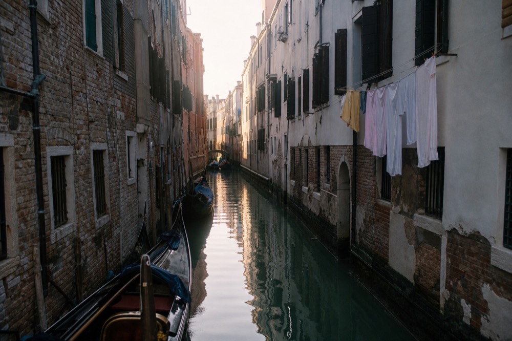 Venice canal with gondolas in morning light, no text, no logos, no people