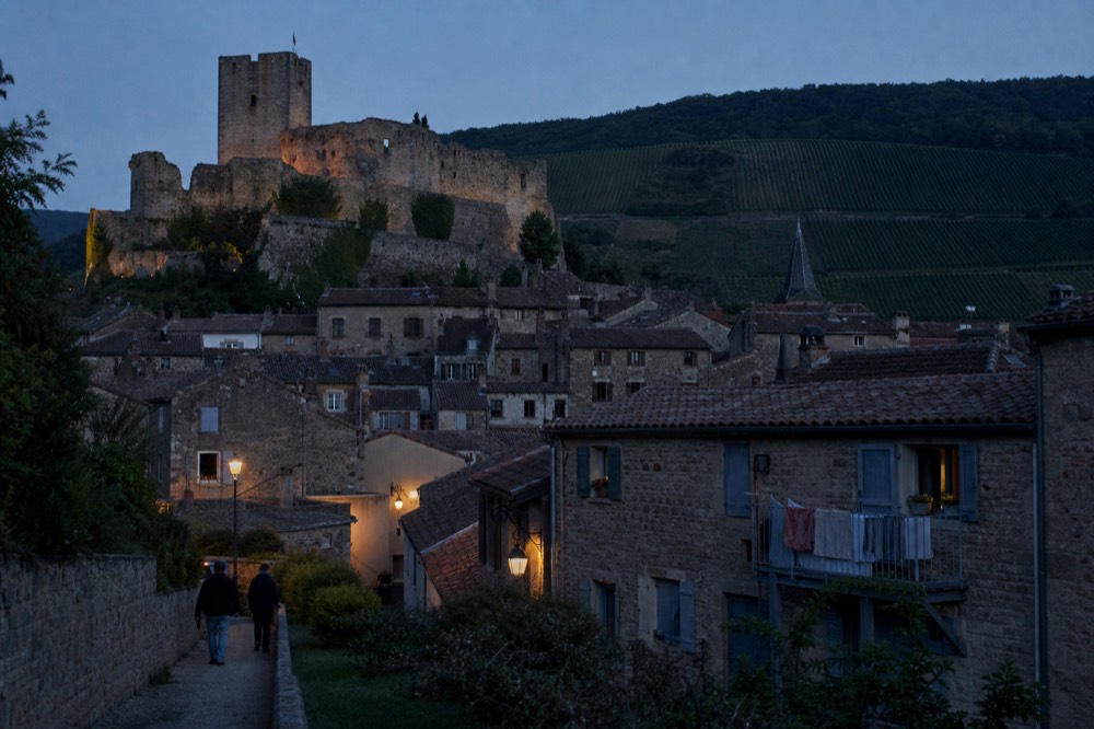 Walled medieval town of Soave with castle and vineyard hills at dusk, no text, no logos, no people