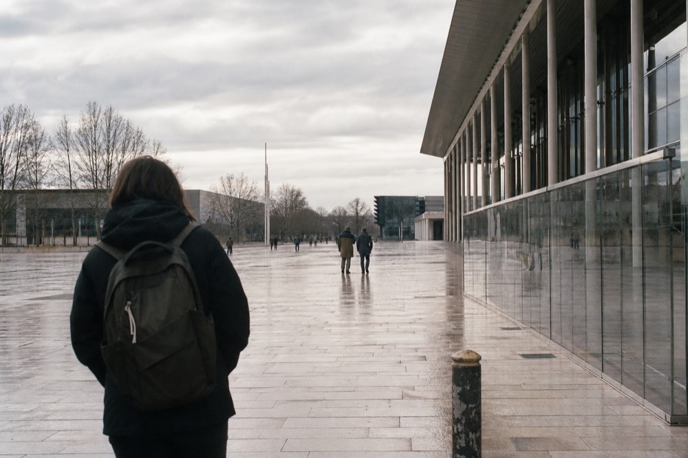 Exterior view of a large exhibition complex with a paved entrance plaza, no text, no logos, no people